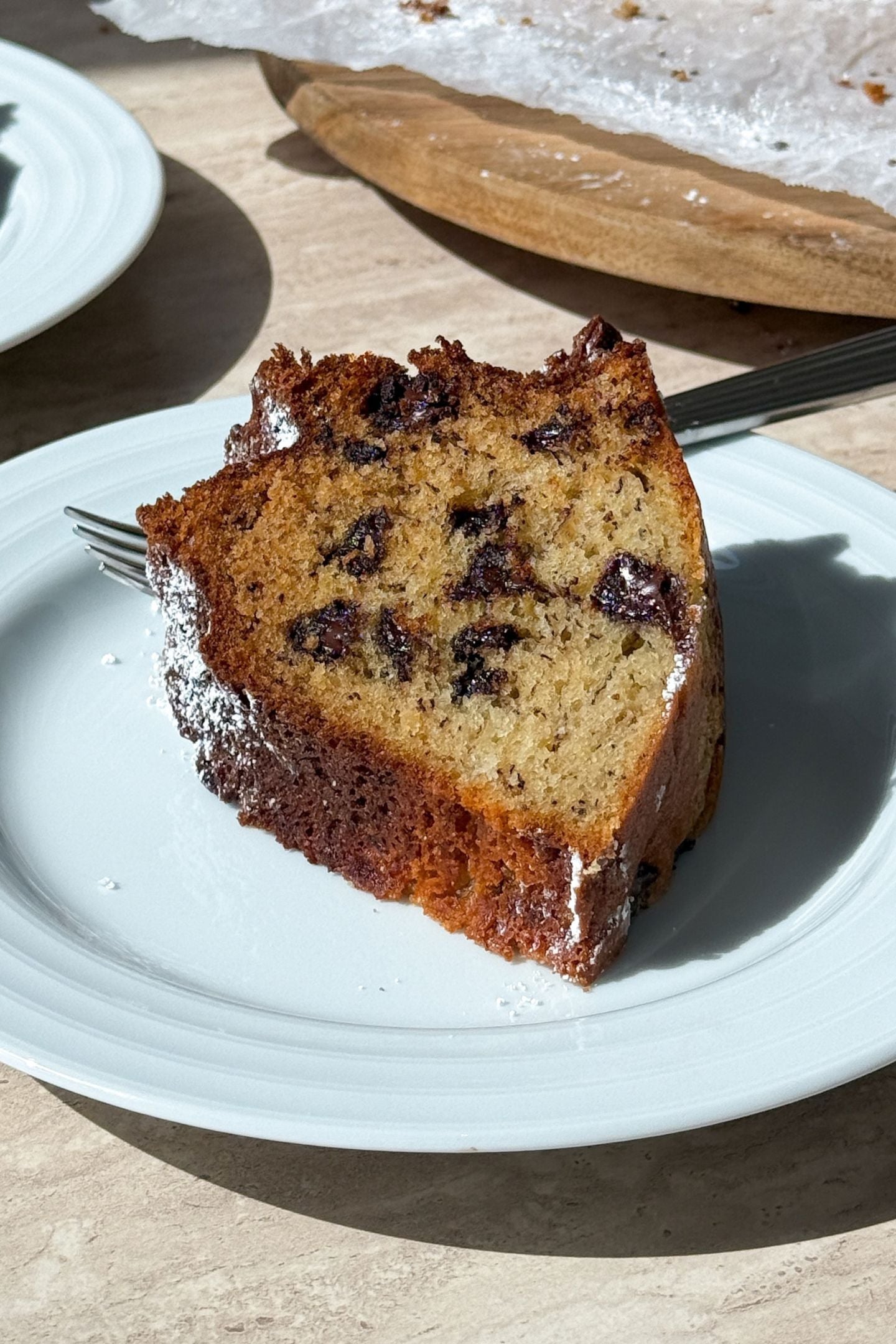 A slice of chocolate chip and banana cake on a plate.